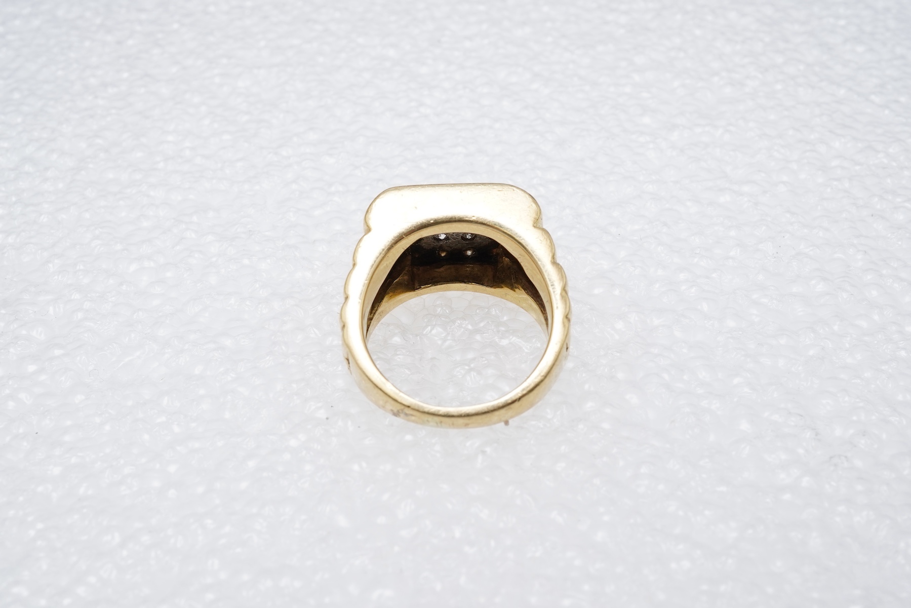 A gold and diamond signet ring